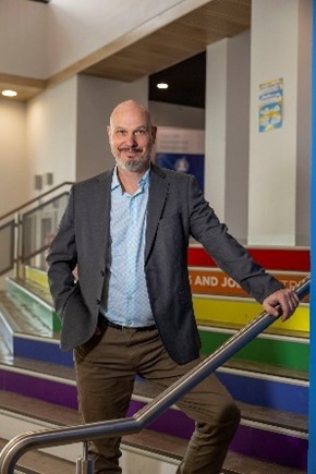 Gavin Wake, Principal of The Gordon’s Senior College on the steps inside the modern Gordon facilities